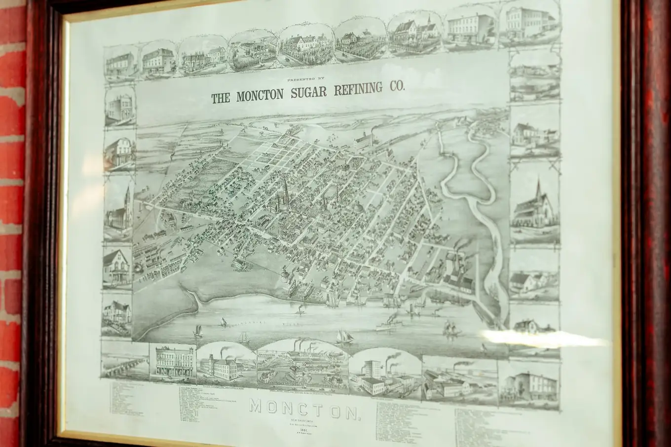 An antique map of Moncton framed on the office wall