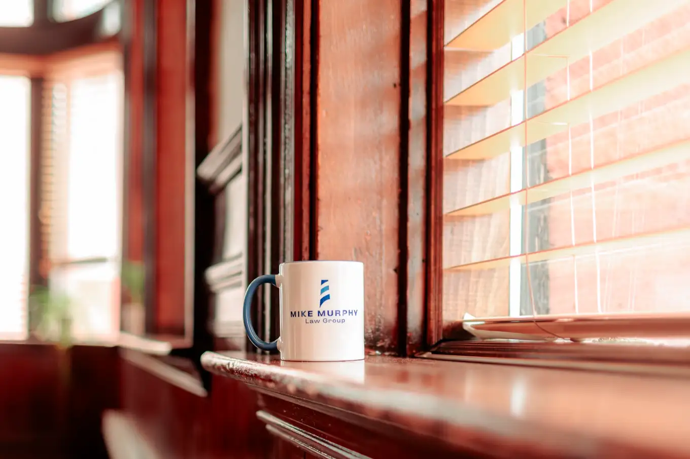 A Mike Murphy Law Group mug on a windowsill in the Moncton office