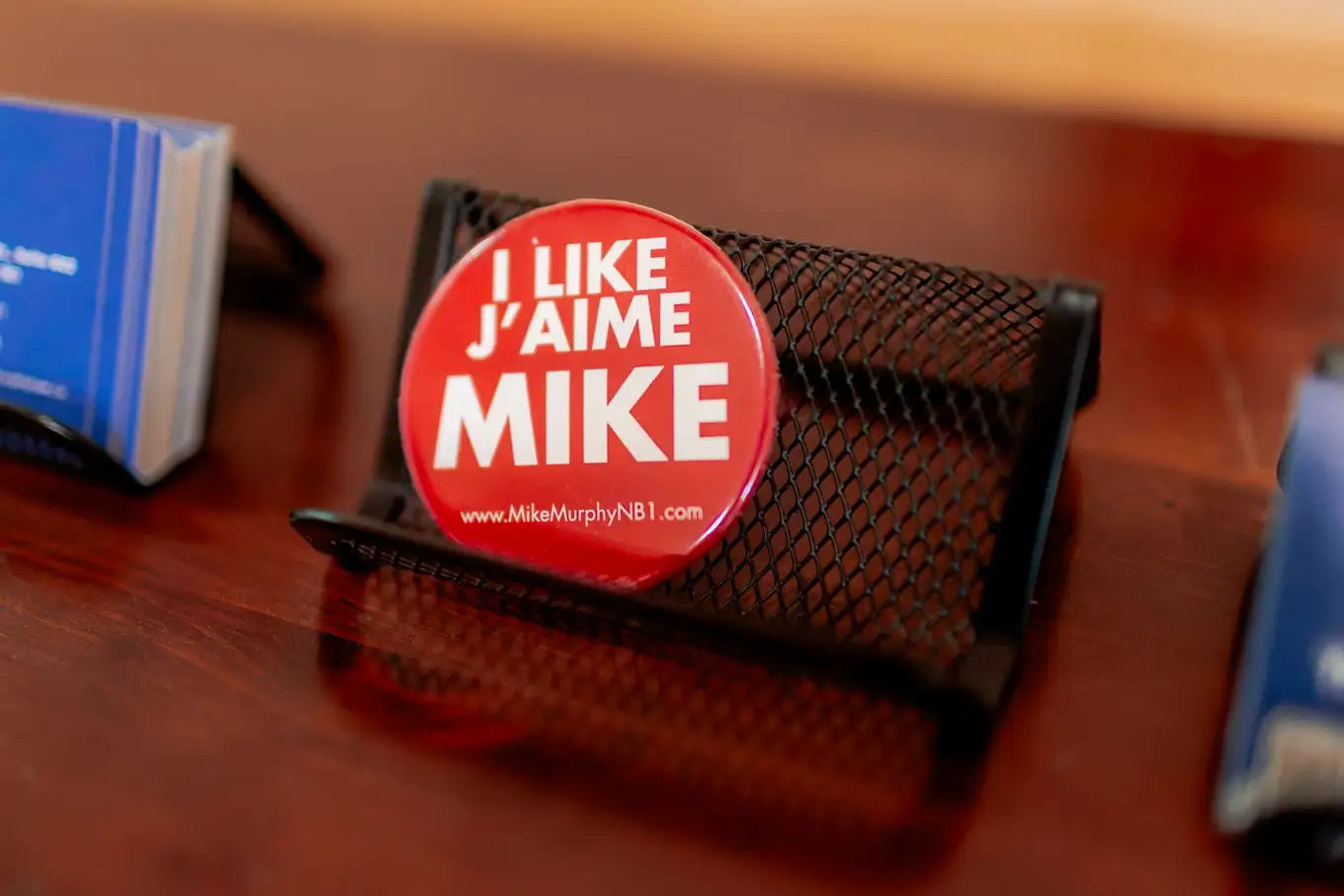 An I Like Mike, J'aime Mike campaign button on a desk