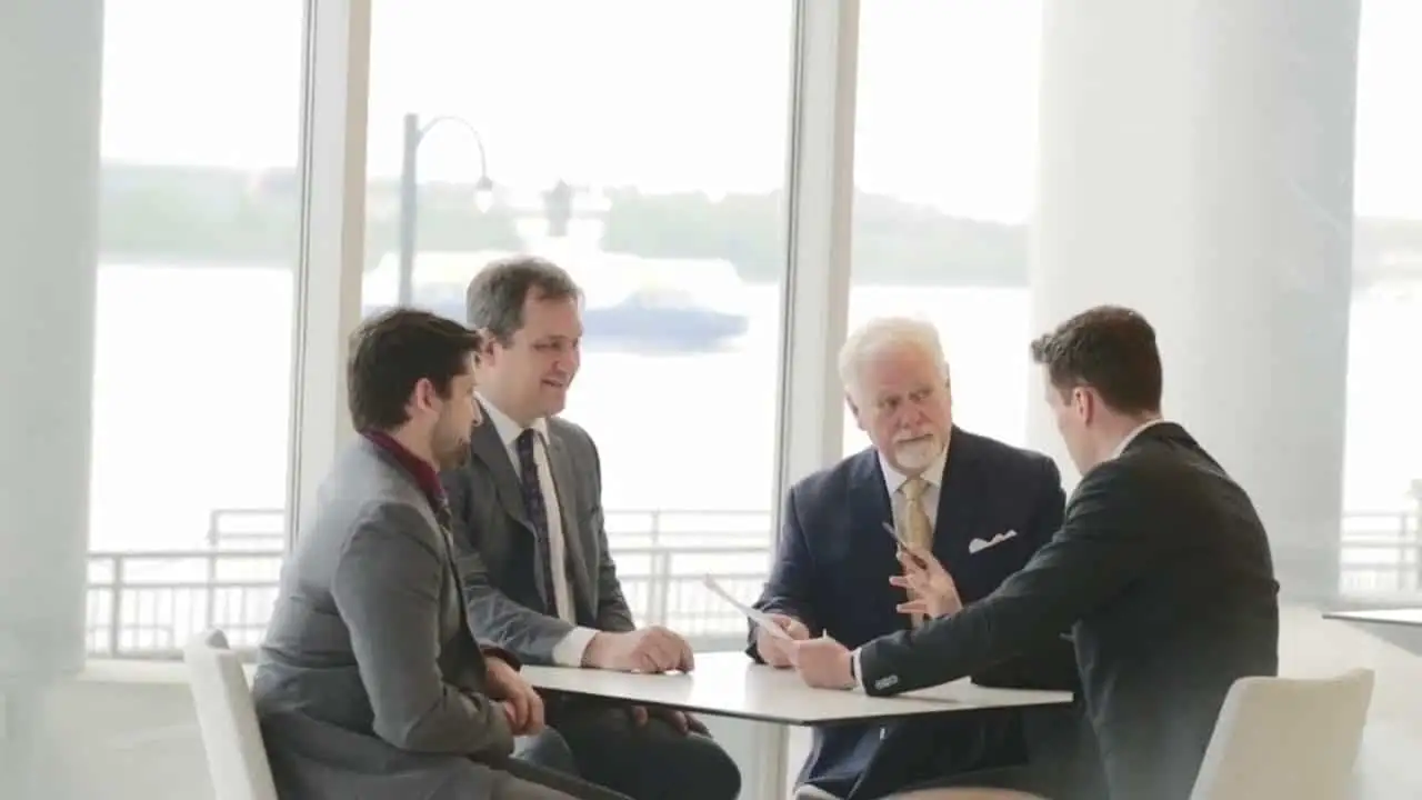 Mike Murphy Law Group lawyers meeting at a table by Halifax harbour