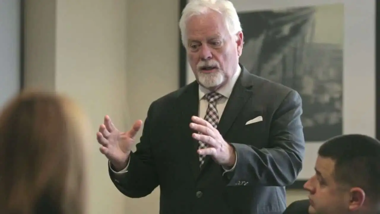 Michael Murphy explaining a case to two colleagues