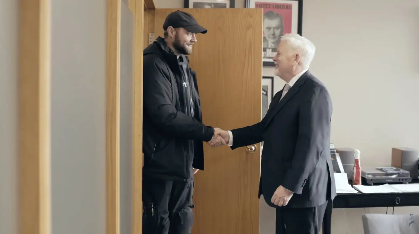 Michael Murphy greeting a client at the office door