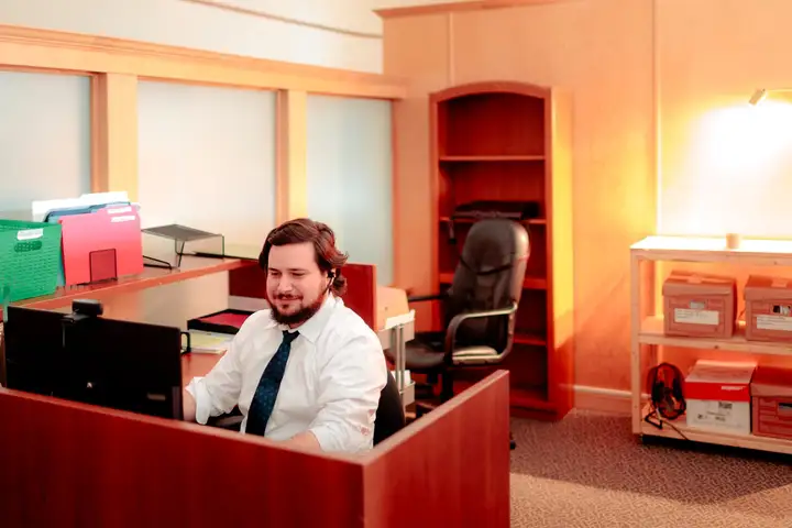 A member of the firm's Moncton team taking a call at the intake desk