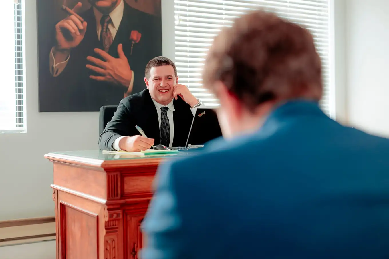 A meeting across a desk in the firm's Moncton office