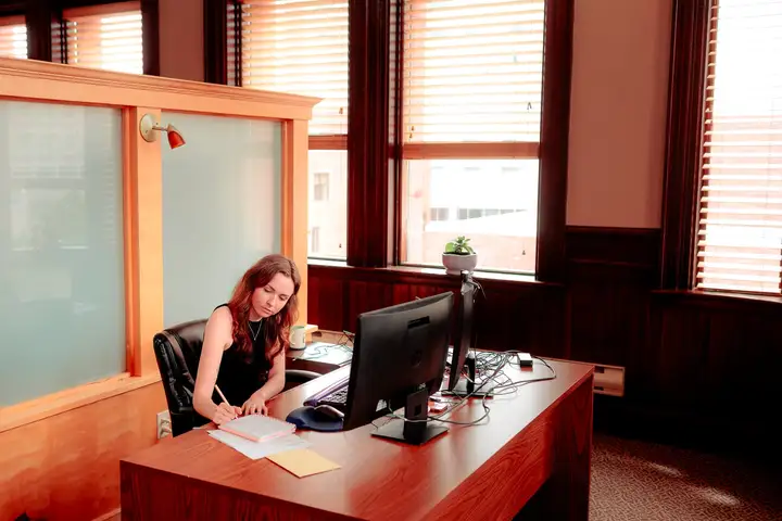 Reviewing papers at a desk in the firm's Moncton office