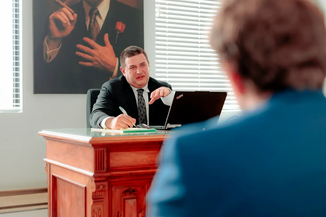Taylor Morin meeting a client across his desk in Moncton